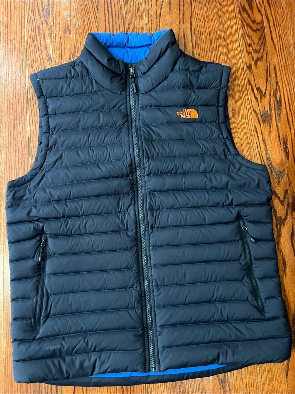 The North Face Black Quilted Down Vest with Blue Lining and Orange Logo